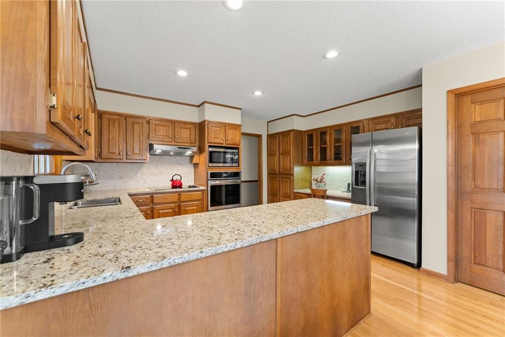 3585 Ridgewood Point Gainesville, GA 30504 - Photo 12 of 41 a kitchen with stainless steel appliances granite countertop a sink refrigerator and cabinets