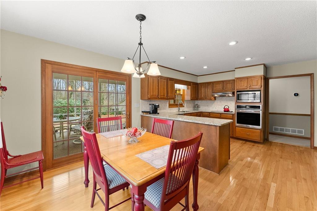 3585 Ridgewood Point Gainesville, GA 30504 - Photo 15 of 41 a view of a dining room and livingroom with furniture wooden floor a chandelier