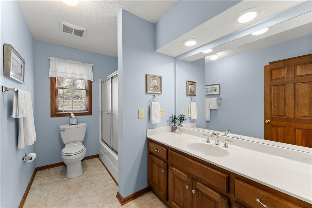 3585 Ridgewood Point Gainesville, GA 30504 - Photo 27 of 41 a spacious bathroom with a double vanity sink toilet and a mirror