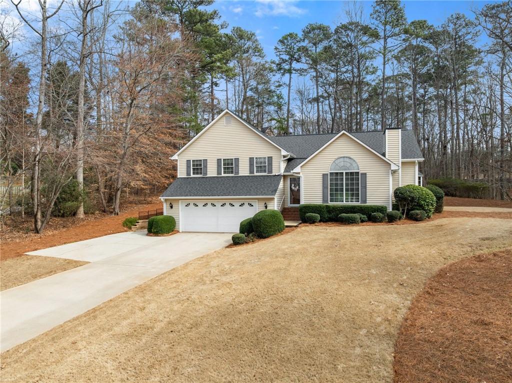 3585 Ridgewood Point Gainesville, GA 30504 - Photo 3 of 41 a front view of a house with a yard and garage