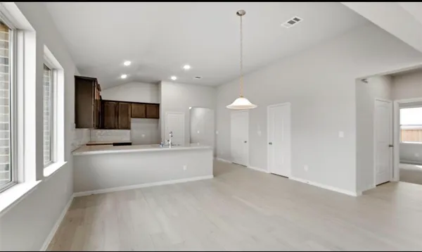 a view of kitchen with sink and refrigerator