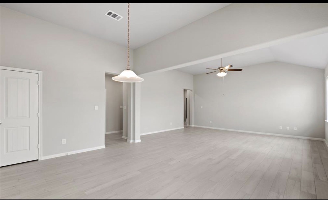 4327 Reese Ravine Lane Katy, TX 77493 - Photo 13 of 34 en empty room with an entryway and chandelier fan