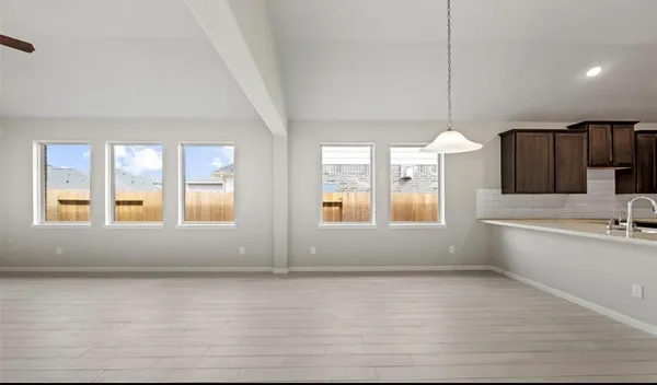 a view of a kitchen with a sink and windows