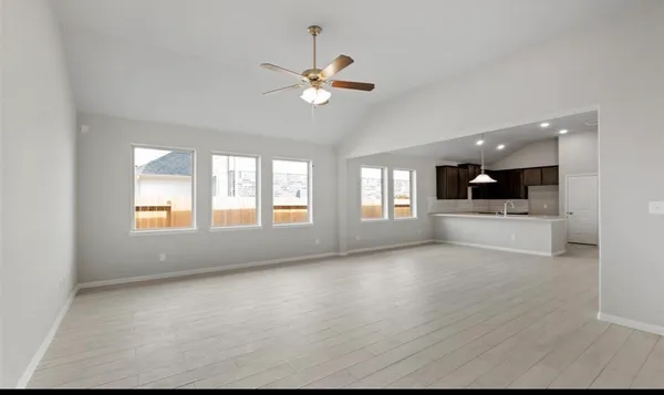 a view of a livingroom with a ceiling fan and window
