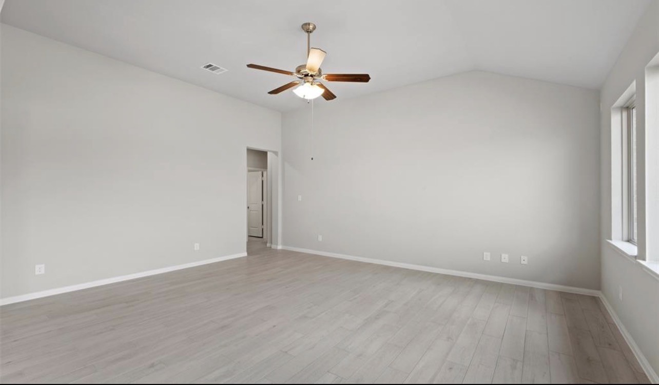 4327 Reese Ravine Lane Katy, TX 77493 - Photo 18 of 34 an empty room with windows and chandelier fan