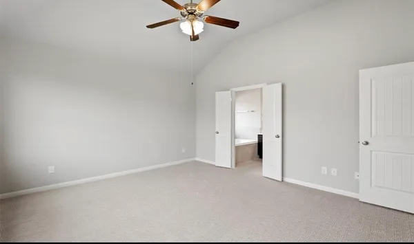 an empty room with a ceiling fan and a window