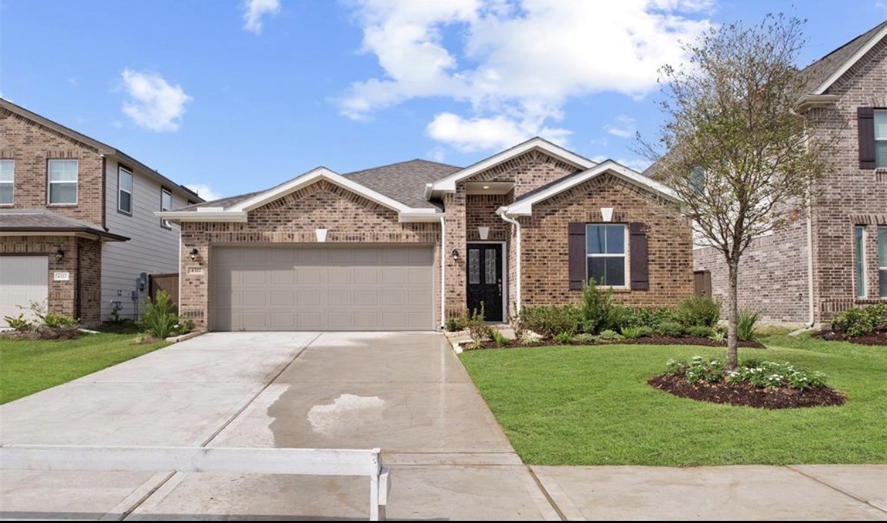 4327 Reese Ravine Lane Katy, TX 77493 - Photo 2 of 34 a front view of a house with a yard and garage