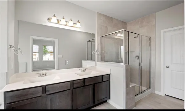 a bathroom with a double vanity sink and mirror