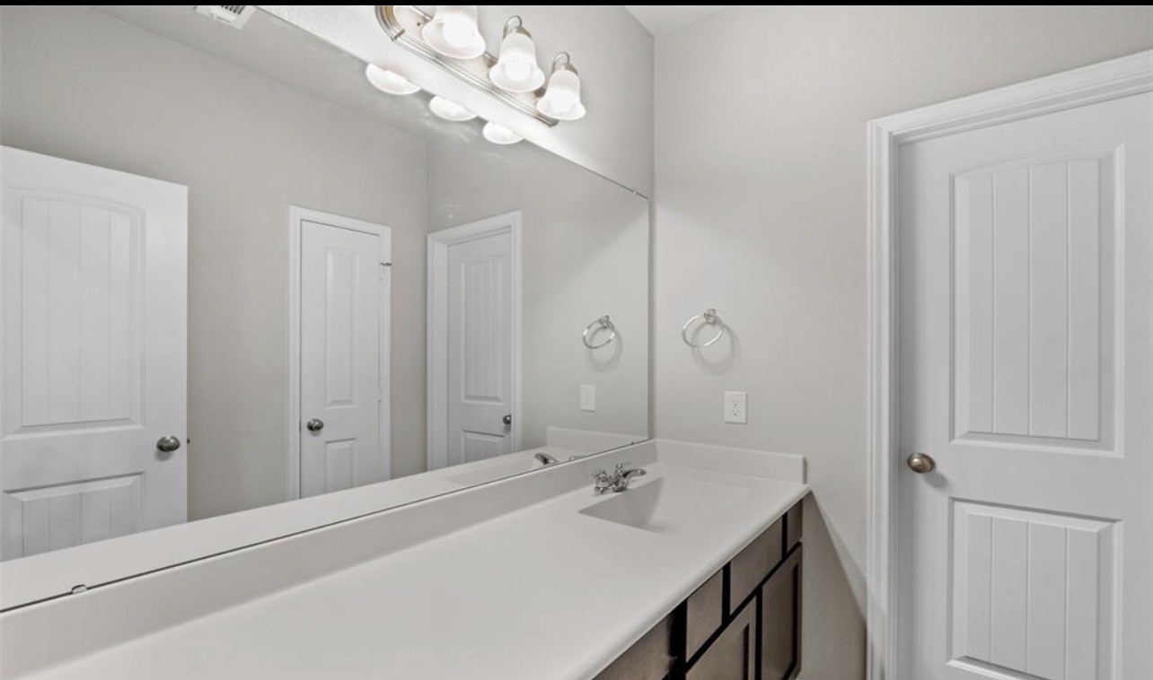 4327 Reese Ravine Lane Katy, TX 77493 - Photo 25 of 34 a bathroom with a sink a light fixture and a mirror