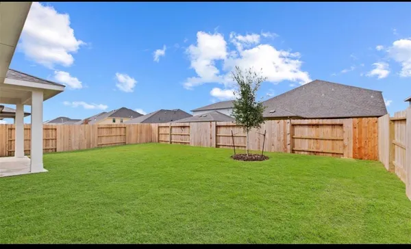 a view of a house with a yard and a garden