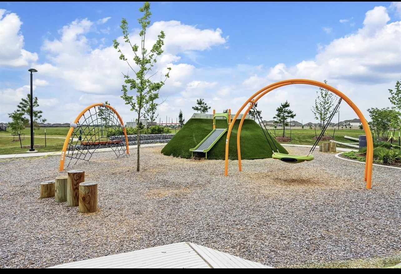 4327 Reese Ravine Lane Katy, TX 77493 - Photo 33 of 34 a view of a garden with a slide