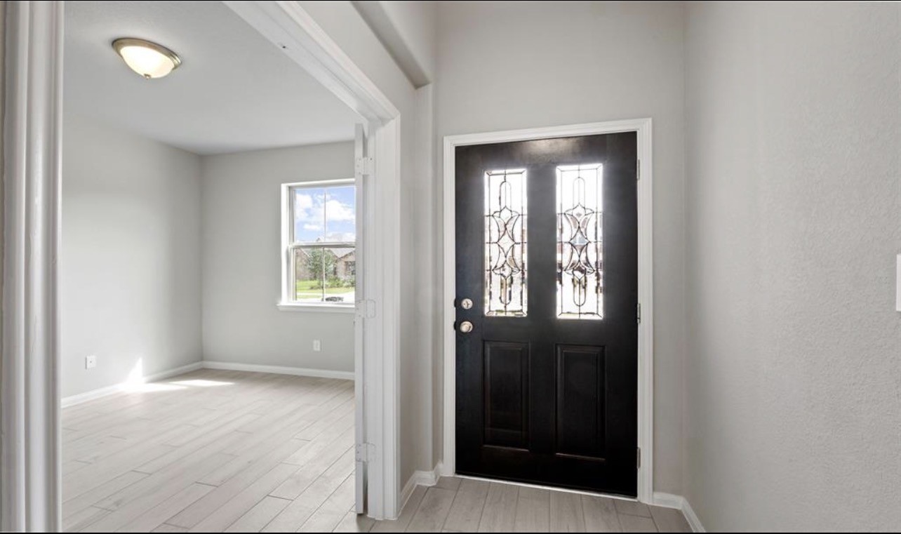 4327 Reese Ravine Lane Katy, TX 77493 - Photo 4 of 34 a view of an empty room with glass door and a window