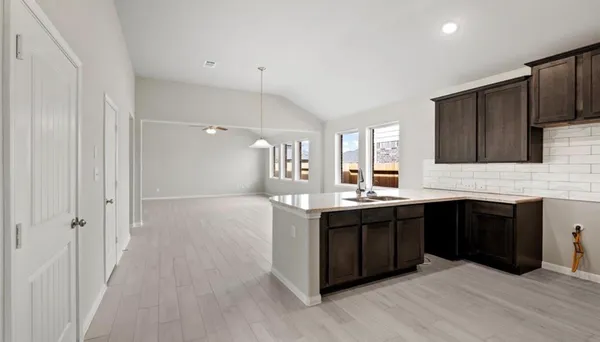 a large kitchen with stainless steel appliances granite countertop a stove and cabinets