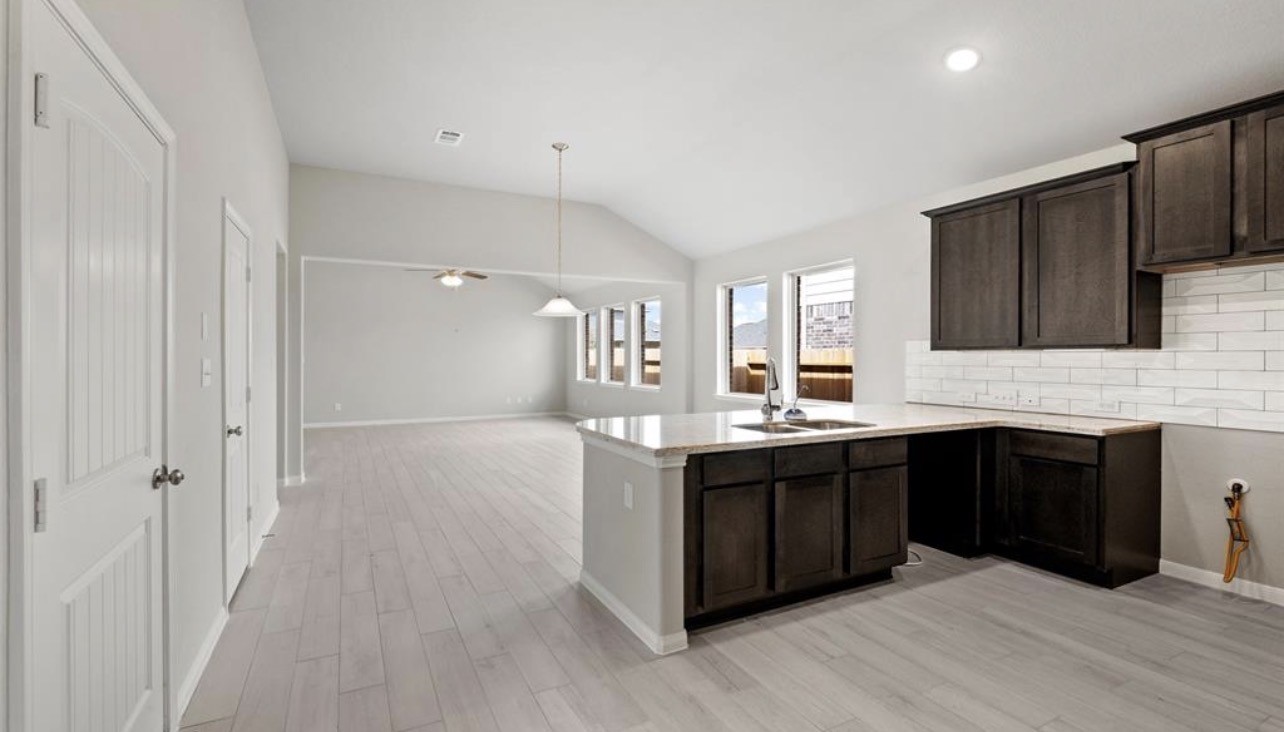 4327 Reese Ravine Lane Katy, TX 77493 - Photo 10 of 34 a large kitchen with stainless steel appliances granite countertop a stove and cabinets