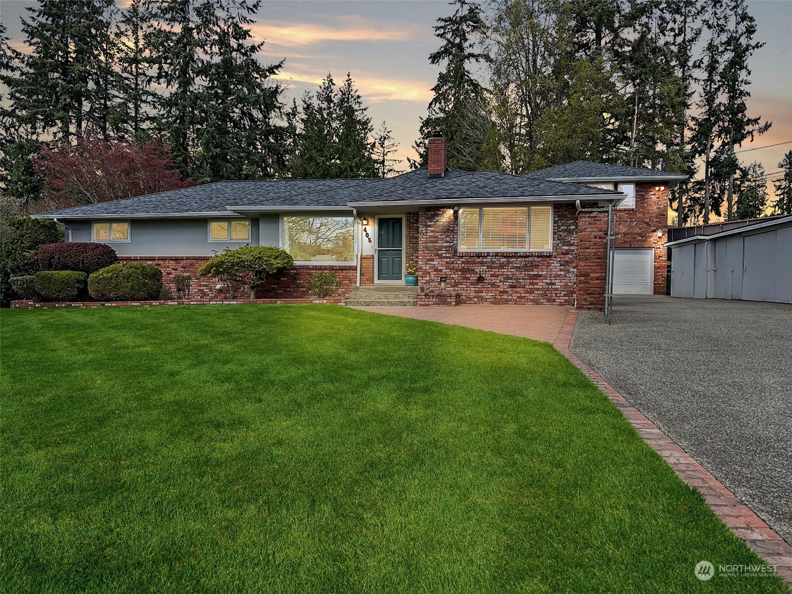 405 240th Street Southwest Bothell, WA 98021 - Photo 1 of 37 a front view of a house with a garden and trees