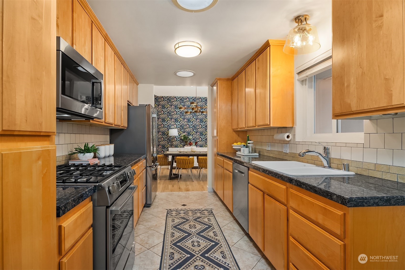 405 240th Street Southwest Bothell, WA 98021 - Photo 14 of 37 a kitchen with stainless steel appliances granite countertop a sink stove and cabinets