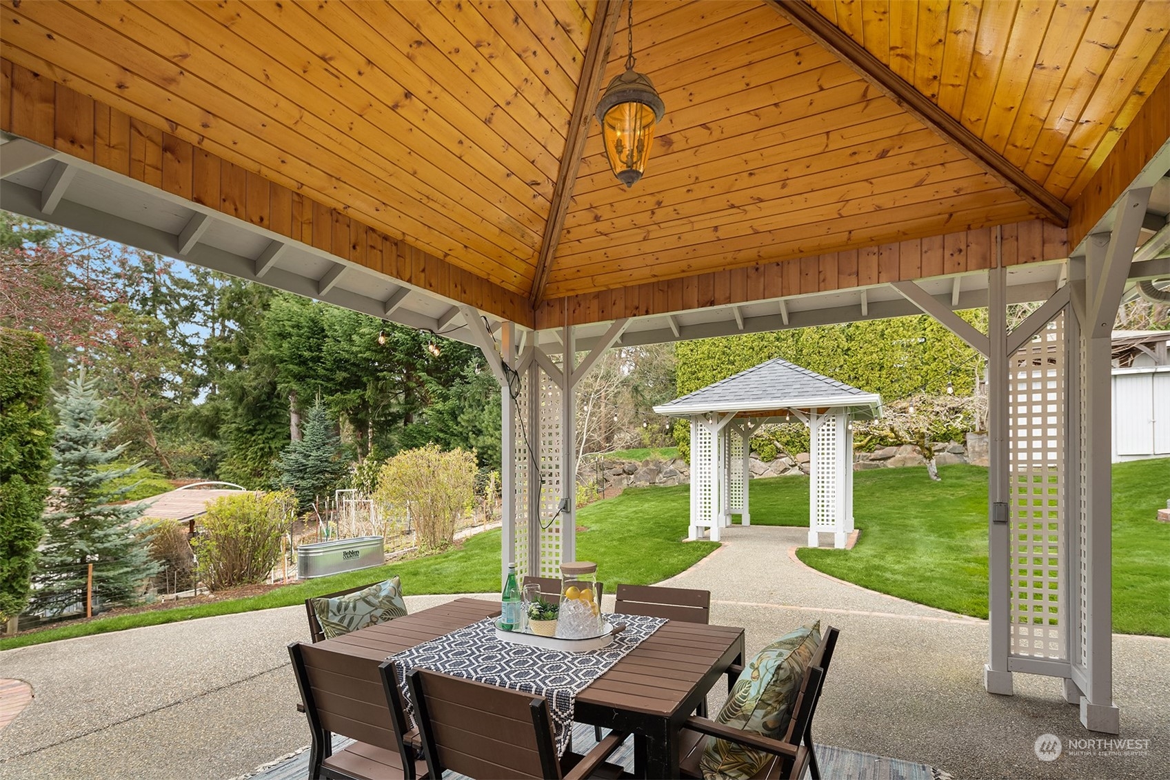 405 240th Street Southwest Bothell, WA 98021 - Photo 18 of 37 a view of a patio with a table chairs and a backyard