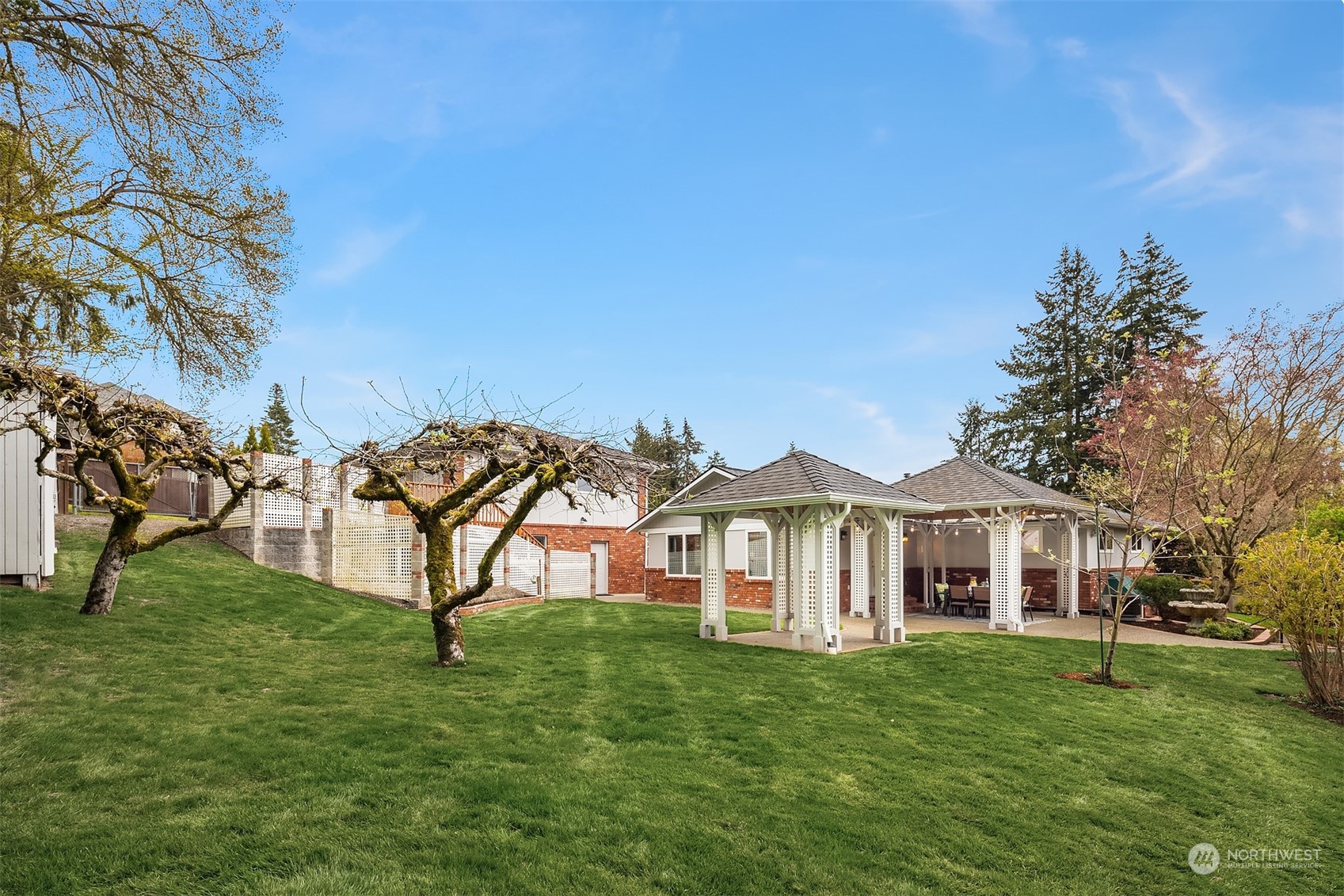 405 240th Street Southwest Bothell, WA 98021 - Photo 27 of 37 a view of a white house with a big yard and large trees
