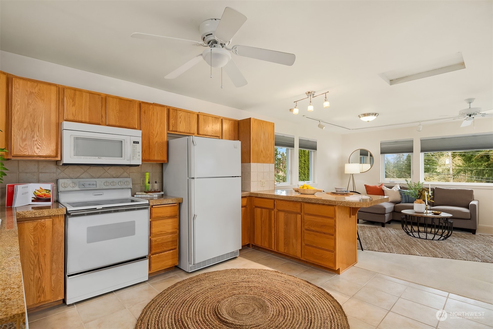 405 240th Street Southwest Bothell, WA 98021 - Photo 30 of 37 a kitchen with stainless steel appliances granite countertop a refrigerator a oven a sink dishwasher and white cabinets with wooden floor
