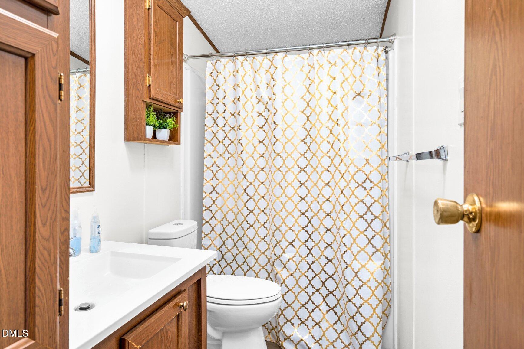 1835 Cokey Road Rocky Mount, NC 27801 - Photo 19 of 42 a bathroom with a sink and toilet