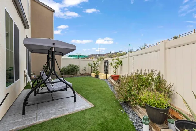 a view of a patio with a table and chairs