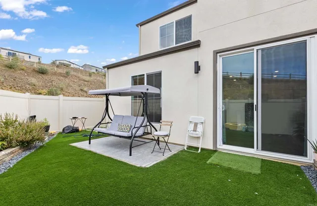 a view of a porch with chairs and backyard