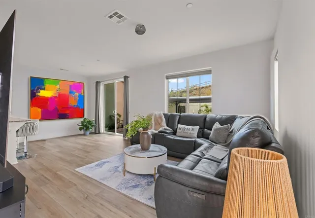a living room with furniture fireplace and window