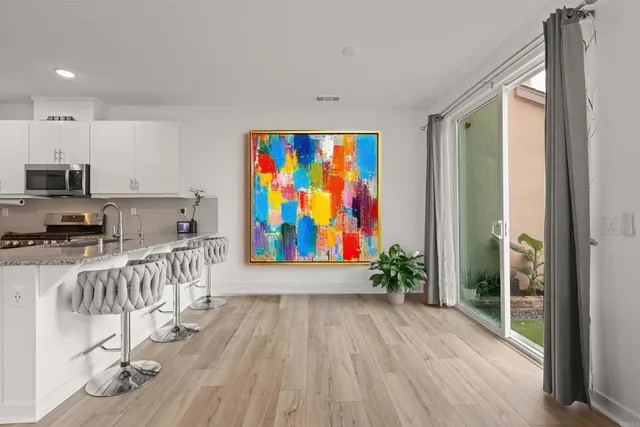 a view of a kitchen with furniture wooden floor and window