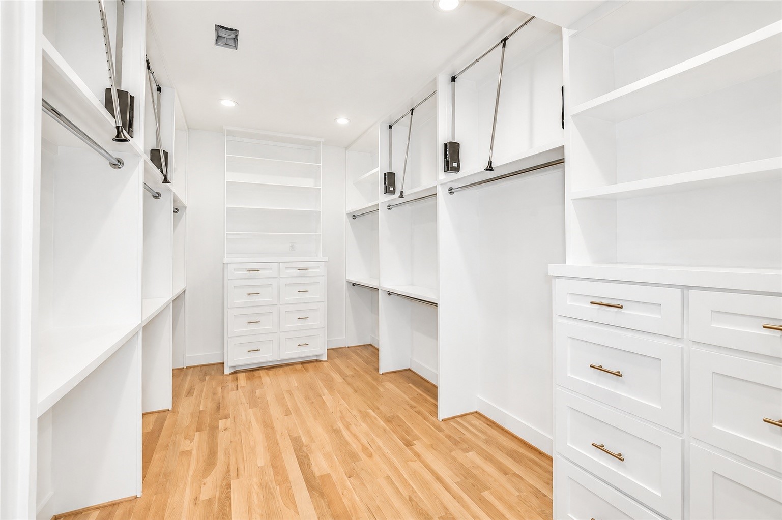 1013 Martin Street Houston, TX 77018 - Photo 25 of 46 Massive walk-in primary closet thoughtfully designed w/extensive built-ins including dressers, hanging space, shelving, & exceptional storage throughout.