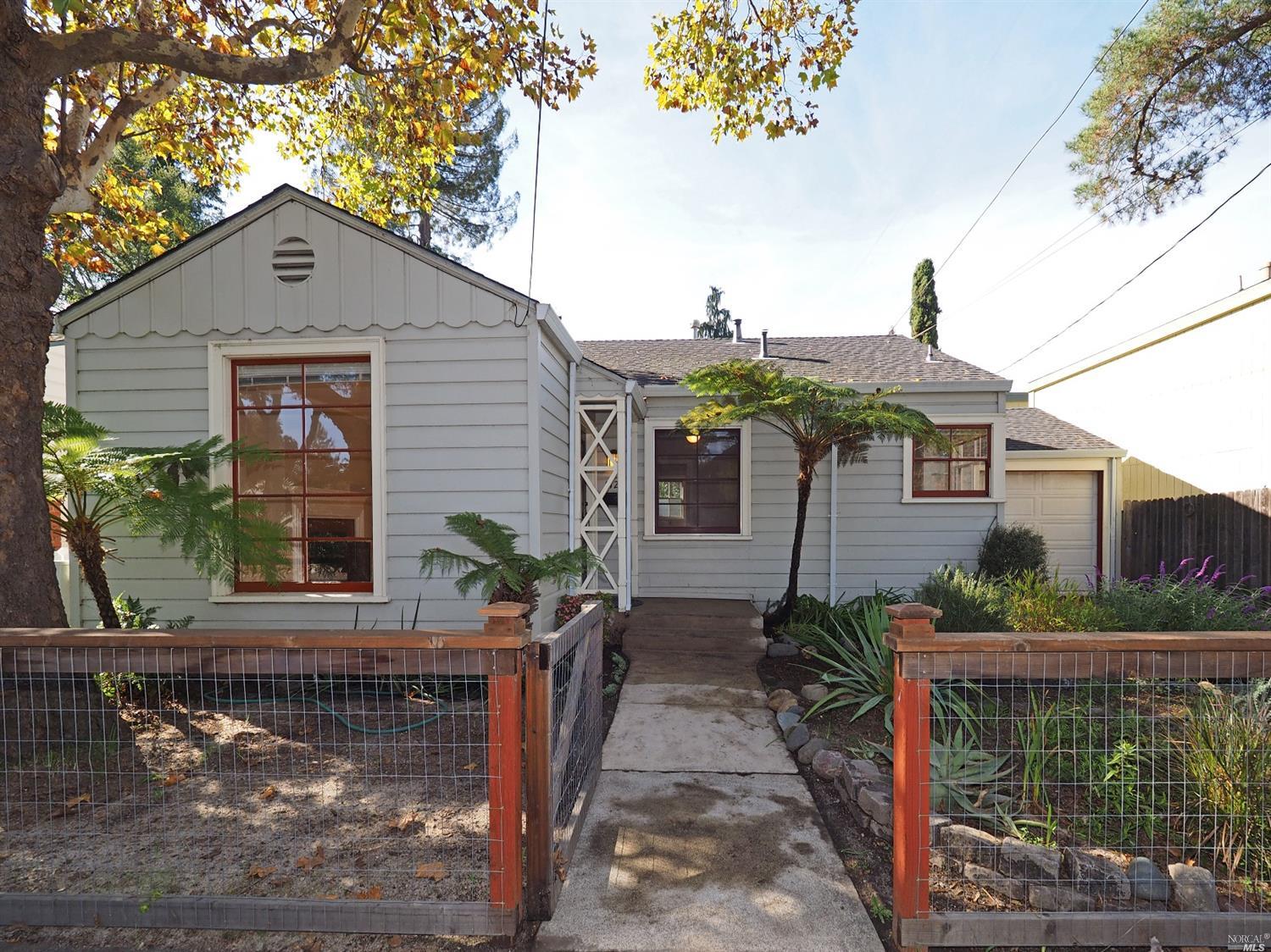 1129 Slater Street Santa Rosa, CA 95404 - Photo 1 of 1 a front view of house with yard and trees in the background