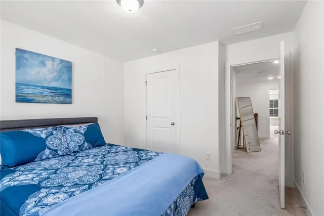 a bedroom with a bed and hallway