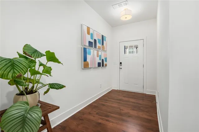 a view of a hallway with wooden floor