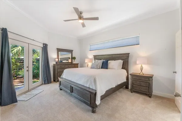 a bedroom with a bed lamp and window