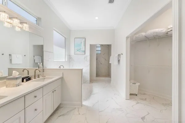 a spacious bathroom with a shower sink and mirror
