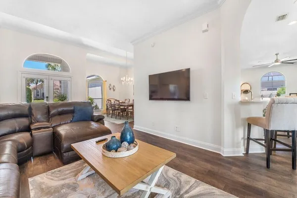 a living room with furniture a flat screen tv and a table