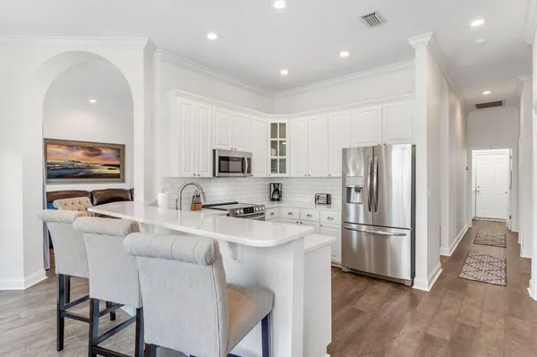 a kitchen with stainless steel appliances a refrigerator stove microwave and cabinets