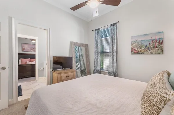 a bedroom with a large bed and a flat tv screen