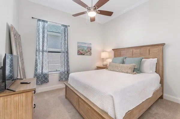 a bedroom with a large bed and a flat tv screen