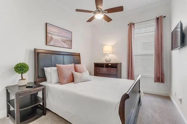 a bed room with a bed and a potted plant