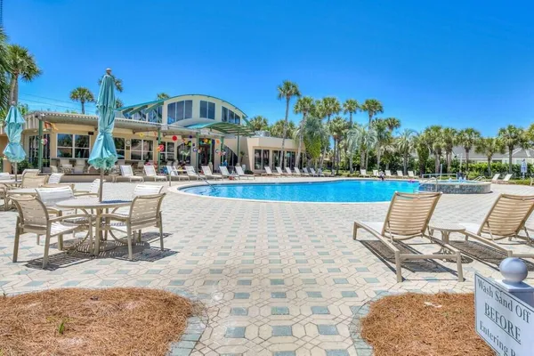 a swimming pool with outdoor seating and yard