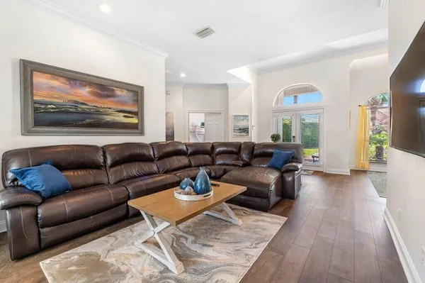 a living room with furniture a couch and wooden floor