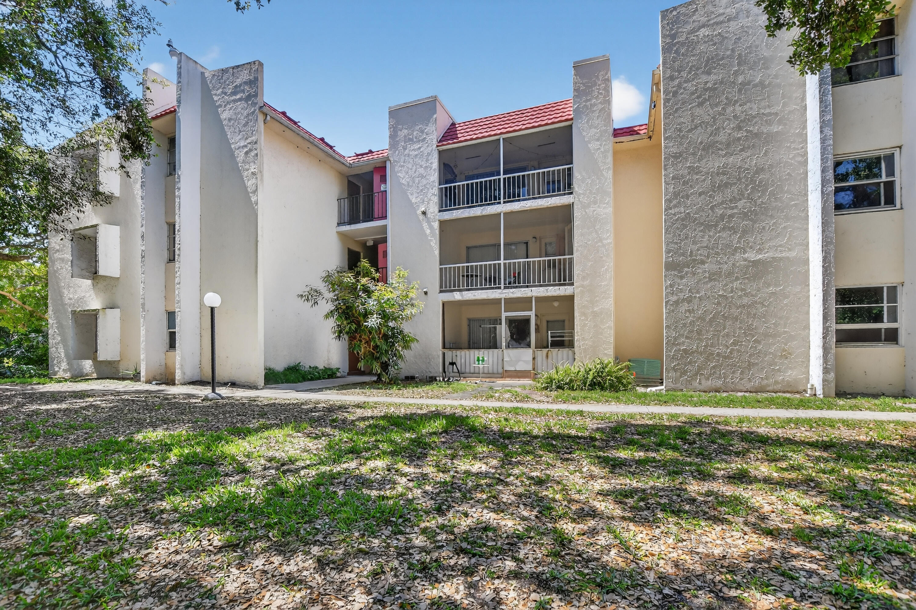 636 Northwest 13th Street, Unit 110 Boca Raton, FL 33486 - Photo 35 of 35 a front view of building with yard