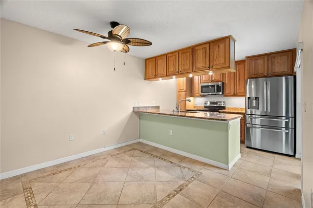 a kitchen with granite countertop a refrigerator and a sink