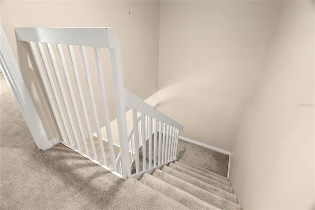 a view of a hallway with stairs