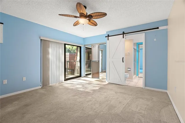 a view of a livingroom with a ceiling fan and window