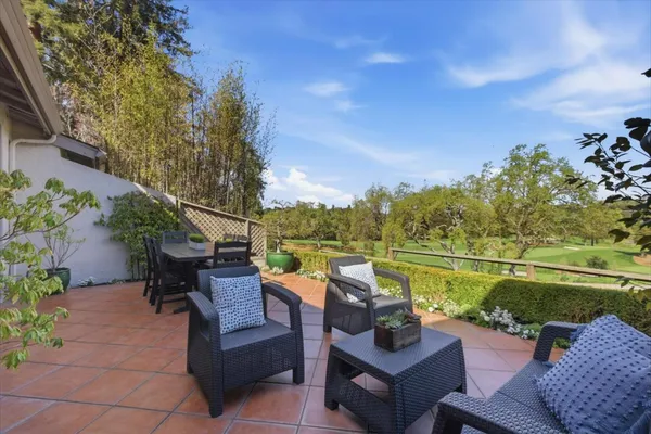 a view of a lake with couches and city view