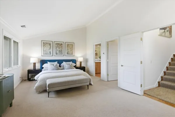 a bedroom with a bed and a couch
