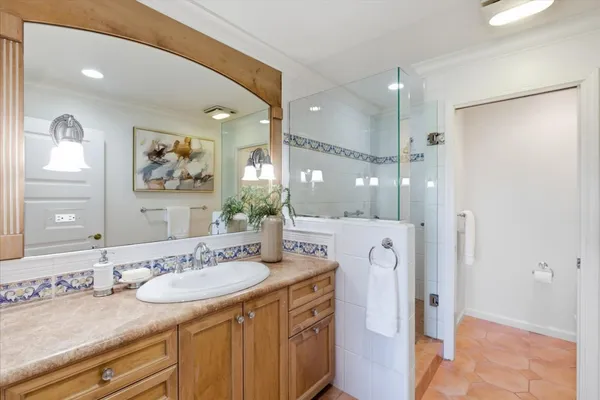 a bathroom with a granite countertop sink mirror and double