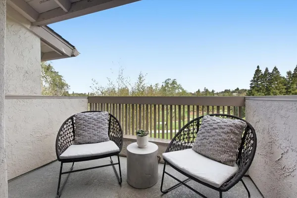 a balcony with table and chairs