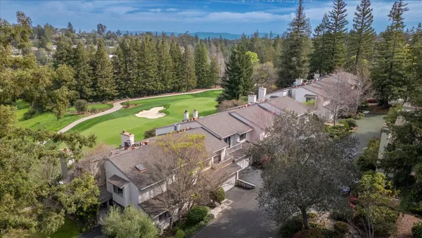 an aerial view of a house with a swimming pool yard and outdoor seating